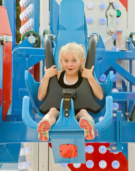 Young girl on amusement park ride